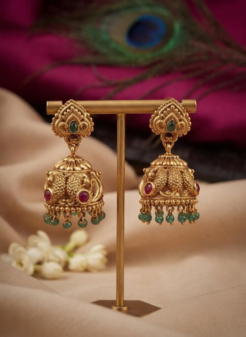 Gold Finish Lakshmi Jhumka Earrings with Green Accents